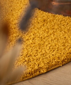 Thick oval rug​ - Shaggy Trend mustard yellow - close up, thumbnail
